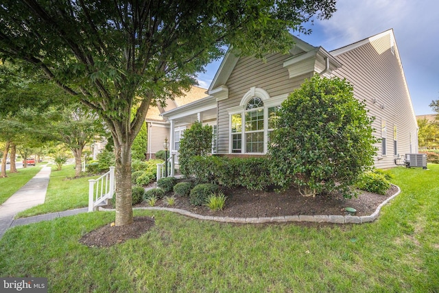 exterior space featuring a yard and cooling unit