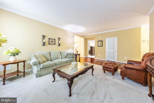 living room with light hardwood / wood-style floors and ornamental molding