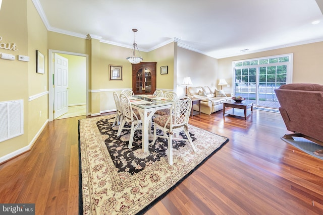 dining space featuring crown molding and dark hardwood / wood-style flooring