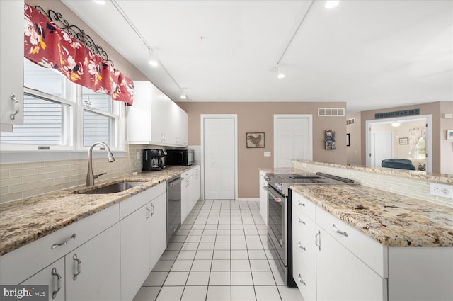 kitchen with white cabinets, rail lighting, stainless steel appliances, and sink