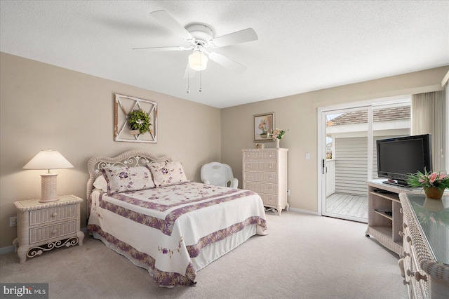 bedroom with ceiling fan, a textured ceiling, and light carpet