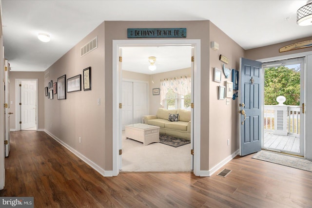 entryway with dark hardwood / wood-style flooring