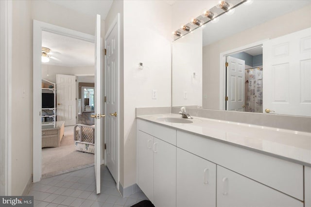 bathroom featuring tile patterned flooring, a textured ceiling, walk in shower, ceiling fan, and vanity