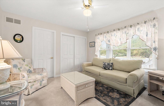 carpeted living room with ceiling fan