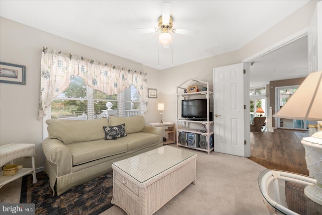 living room with light carpet, ceiling fan, and a wealth of natural light