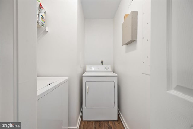 laundry room featuring washing machine and clothes dryer and dark hardwood / wood-style flooring