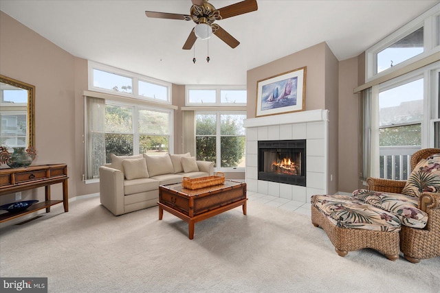 living room with a fireplace, ceiling fan, light colored carpet, and plenty of natural light