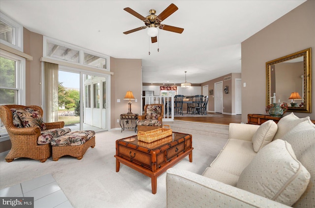 living room featuring light wood-type flooring and ceiling fan