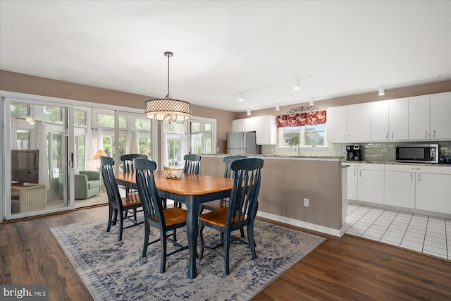 dining room featuring dark hardwood / wood-style floors, a chandelier, and a healthy amount of sunlight