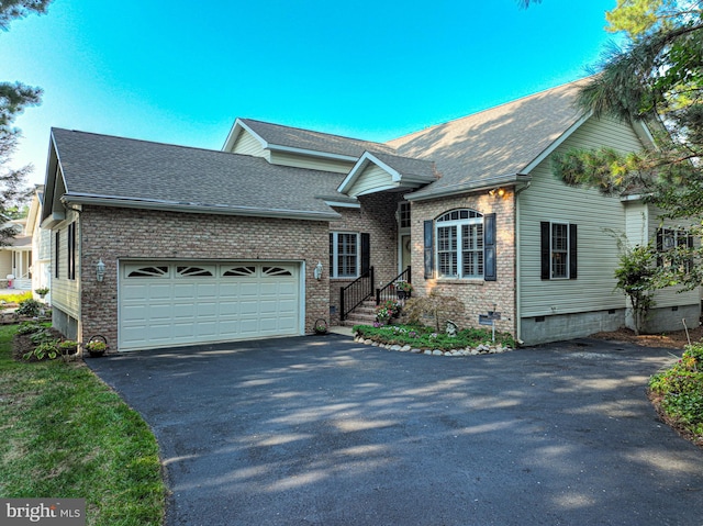 view of front of house featuring driveway, crawl space, an attached garage, and roof with shingles