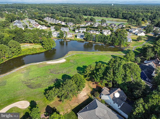 birds eye view of property featuring a forest view, a water view, and a residential view