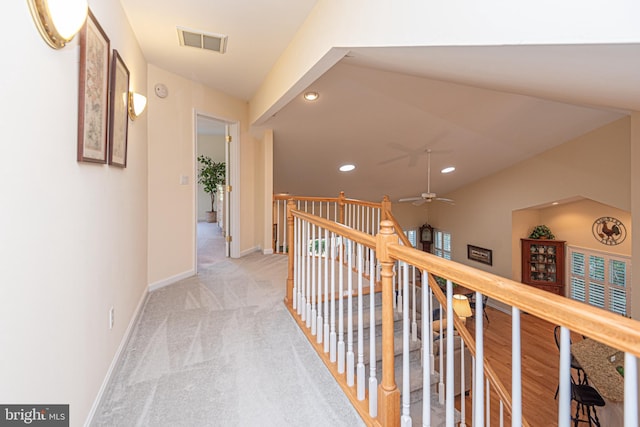 hallway featuring recessed lighting, visible vents, light carpet, an upstairs landing, and baseboards