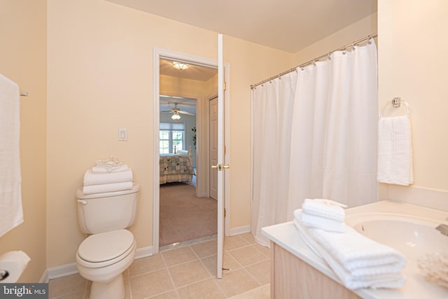 bathroom featuring toilet, connected bathroom, vanity, tile patterned flooring, and baseboards