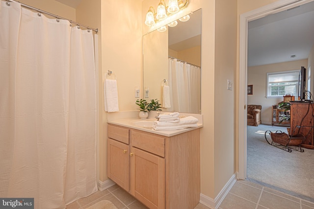 bathroom with tile patterned flooring, vanity, and baseboards