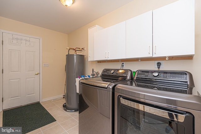 clothes washing area featuring cabinet space, water heater, separate washer and dryer, and light tile patterned flooring