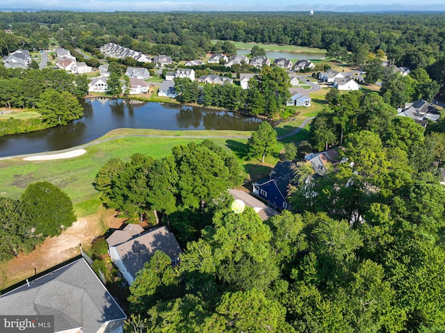 birds eye view of property with a residential view, a water view, and a view of trees