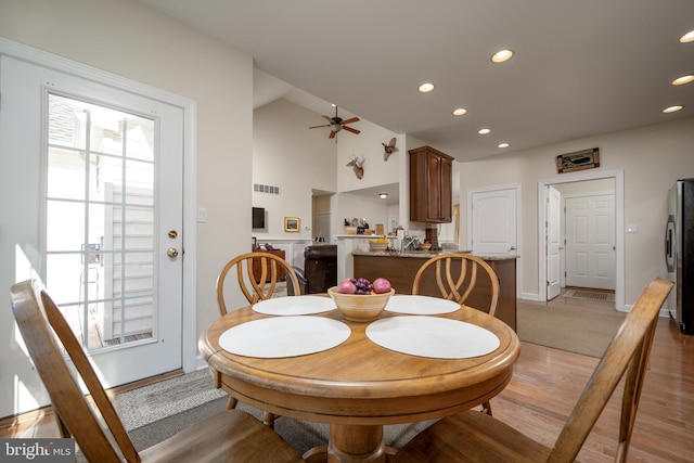 dining area with ceiling fan, plenty of natural light, and light hardwood / wood-style flooring