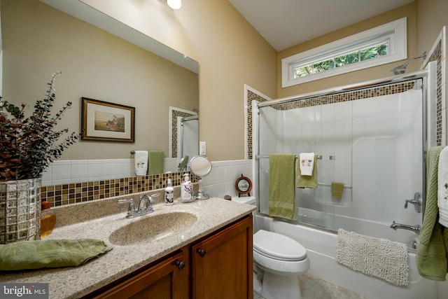 full bathroom featuring backsplash, combined bath / shower with glass door, toilet, and vanity