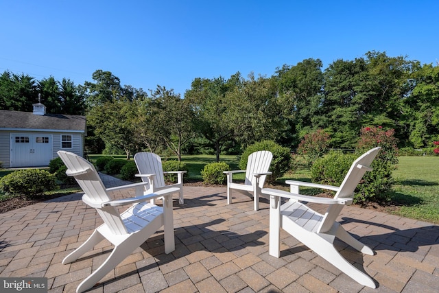 view of patio / terrace featuring an outbuilding