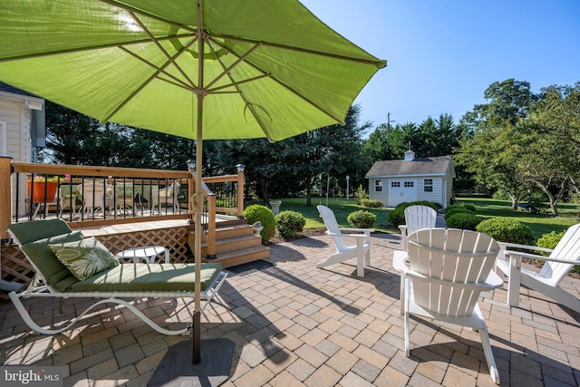 view of patio / terrace with a deck and an outbuilding