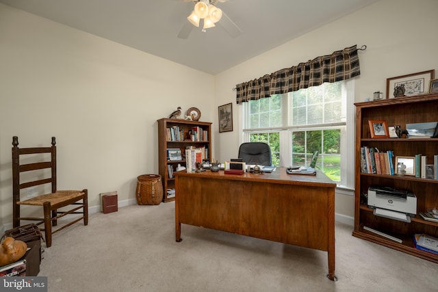 office area with light colored carpet, ceiling fan, and baseboards