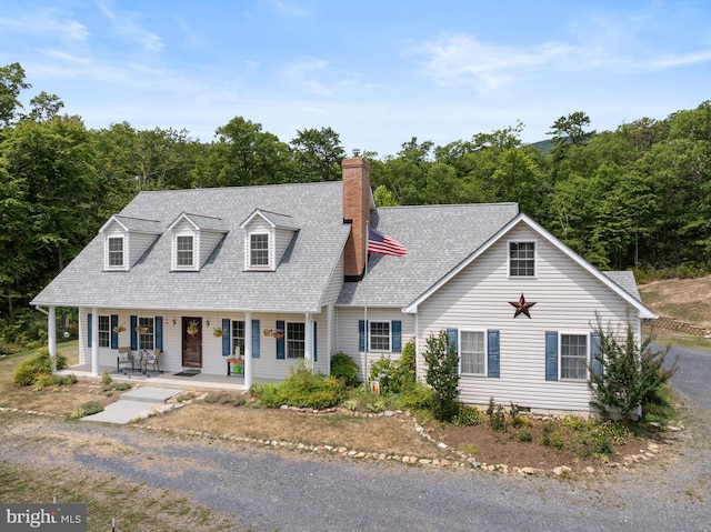 new england style home featuring covered porch