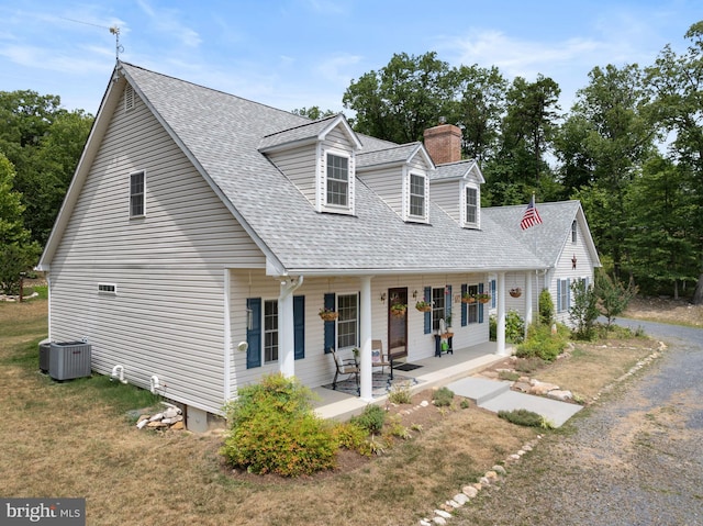 cape cod house featuring central air condition unit and a porch