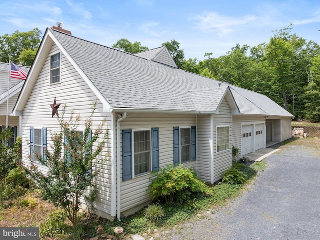 view of side of property featuring an outbuilding and a garage