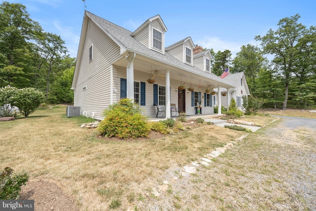 cape cod-style house featuring a porch and a front yard