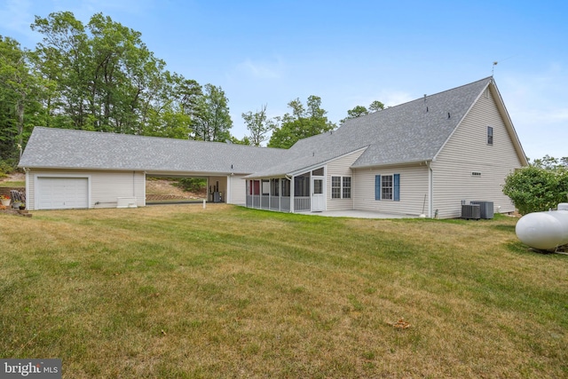 rear view of house featuring central AC unit and a yard