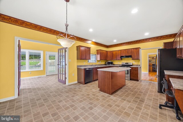 kitchen featuring hanging light fixtures, light hardwood / wood-style floors, sink, a center island, and stainless steel appliances