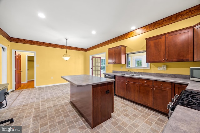 kitchen with sink, range with gas stovetop, light colored carpet, a kitchen island, and hanging light fixtures