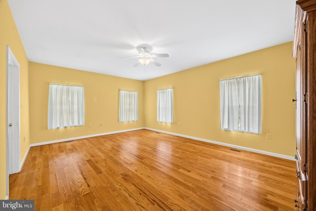 empty room with light hardwood / wood-style floors and ceiling fan