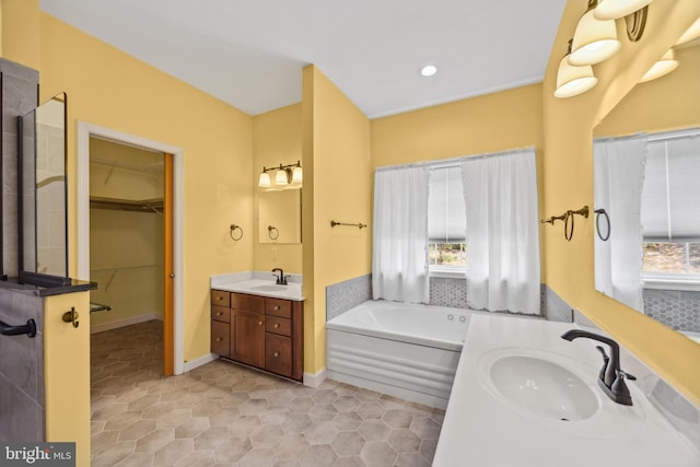 bathroom featuring tile patterned flooring, a tub, and double sink vanity