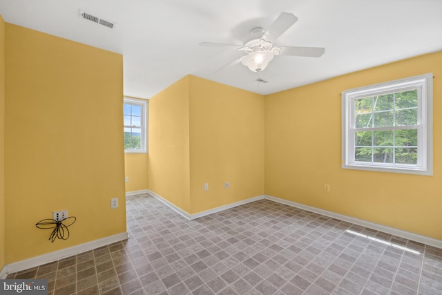 unfurnished room with tile patterned flooring and ceiling fan