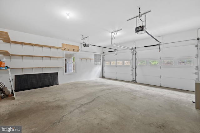 garage with a garage door opener and electric panel