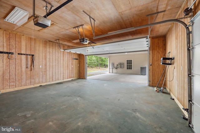 garage with wood walls, a garage door opener, cooling unit, and wood ceiling