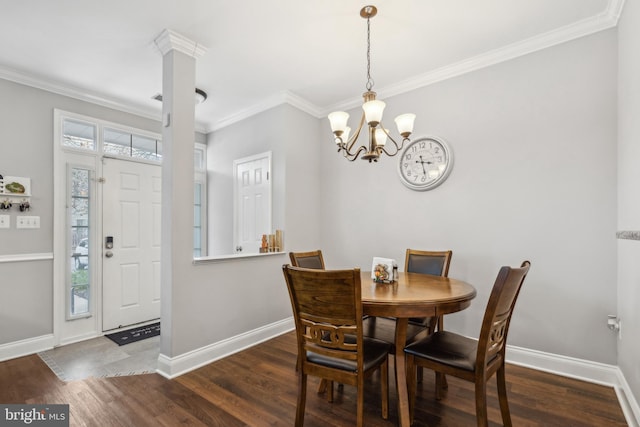 dining room featuring a chandelier, a healthy amount of sunlight, dark hardwood / wood-style floors, and ornamental molding