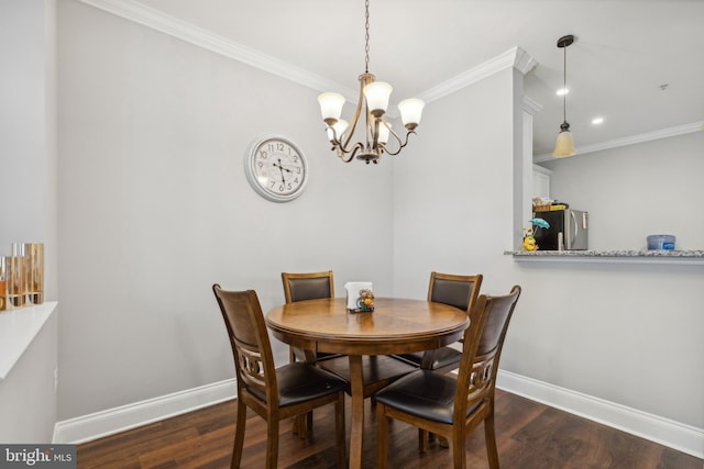 dining space featuring a chandelier, dark hardwood / wood-style floors, and crown molding