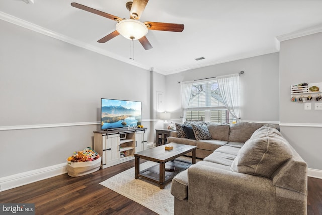 living room with ceiling fan, ornamental molding, and dark wood-type flooring