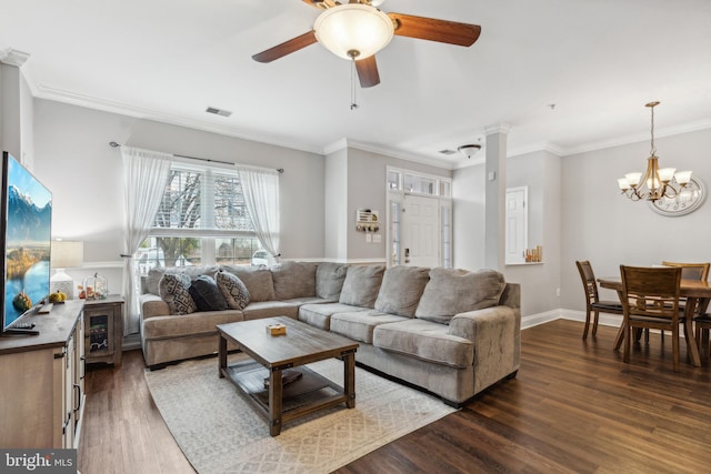 living room with dark hardwood / wood-style floors, crown molding, and ceiling fan with notable chandelier