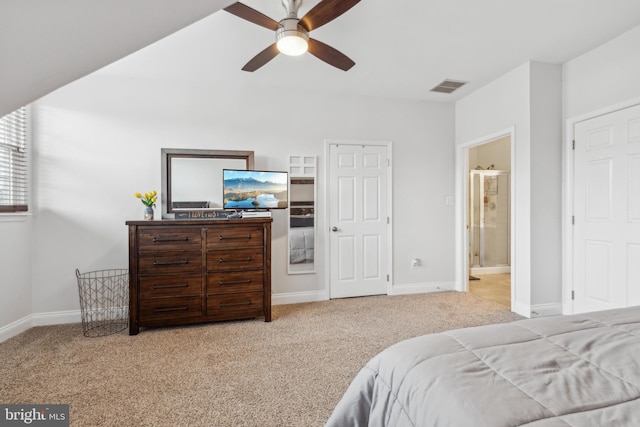 bedroom featuring light carpet, ensuite bath, and ceiling fan