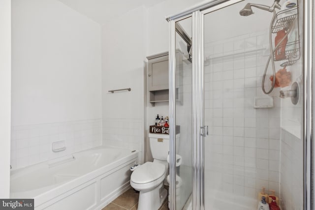 bathroom featuring plus walk in shower, tile patterned flooring, and toilet