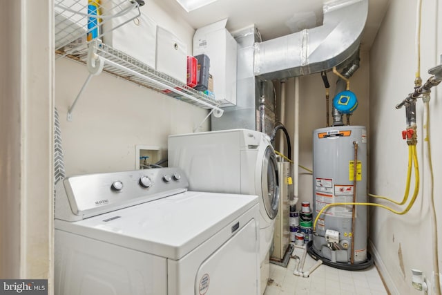 laundry area with washer and dryer and gas water heater