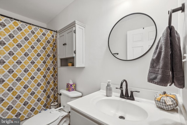 bathroom featuring vanity and toilet