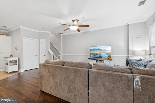 living room featuring dark hardwood / wood-style floors, ceiling fan, and ornamental molding