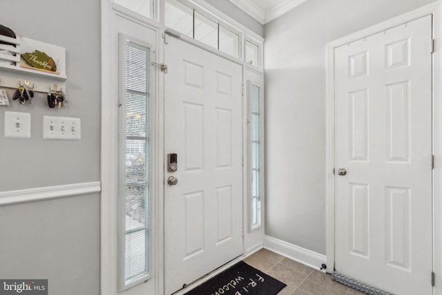 tiled entrance foyer featuring ornamental molding