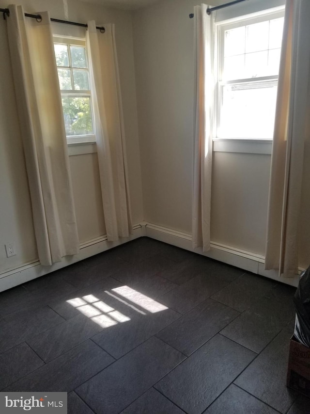 unfurnished room with dark tile patterned floors