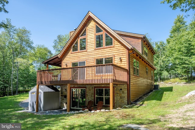 back of property featuring an outdoor structure, a lawn, faux log siding, a shed, and a chimney