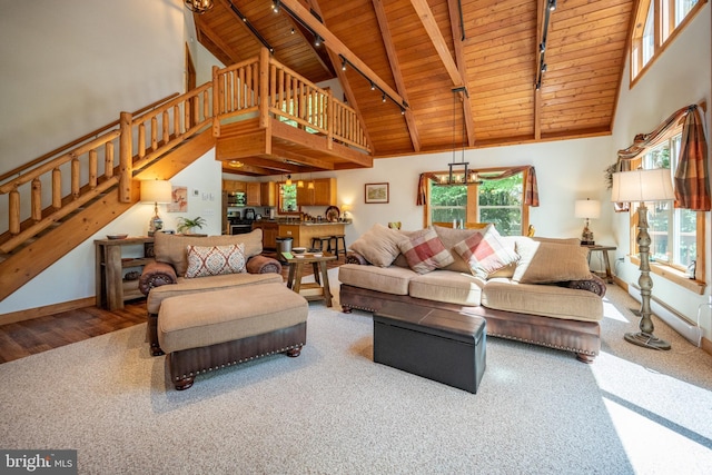 living area with a healthy amount of sunlight, wood ceiling, and high vaulted ceiling